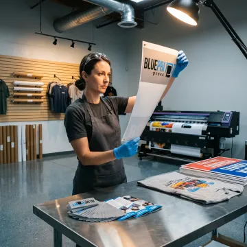 Print specialist reviewing colorful marketing materials