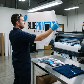 Print technician reviewing colorful banner artwork
