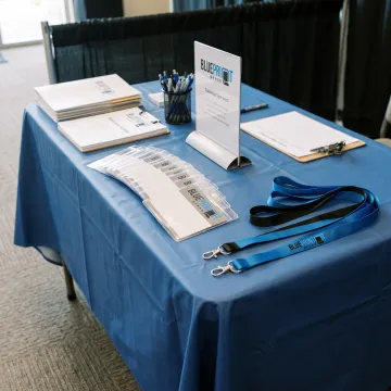 Custom convention name tags displayed at a conference registration table
