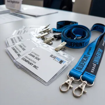 Printed convention name tags and branded lanyards ready for attendees