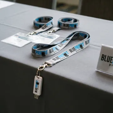 Branded USB flash drive lanyards arranged for an event