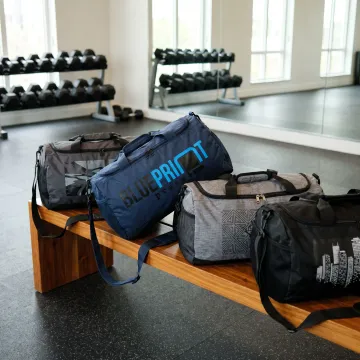 Custom branded gym duffle bags displayed in a fitness studio