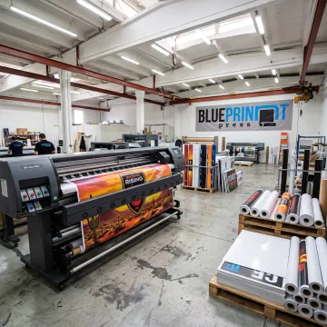 Large format printer producing colorful banner graphics