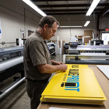 Printer preparing colorful yard signs