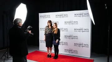Step-and-repeat backdrop with repeating logos at corporate brand event