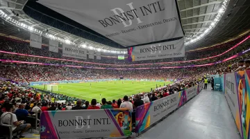 Large-format sublimated fabric barrier covers installed at stadium venue perimeter