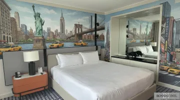 Custom hotel guest room wallcovering installation featuring New York City immersive mural artwork