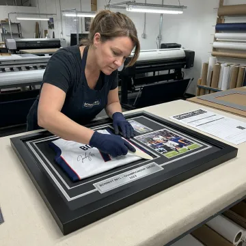Designer arranging double-matted autograph frame