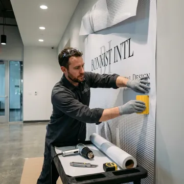 Installer applying a branded vinyl wall wrap