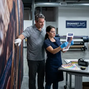Team reviewing printed stage backdrop production