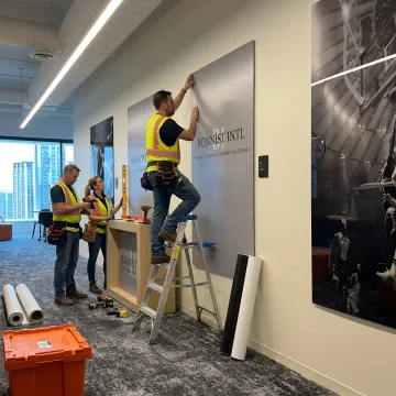 Fabricators installing branded environmental graphics