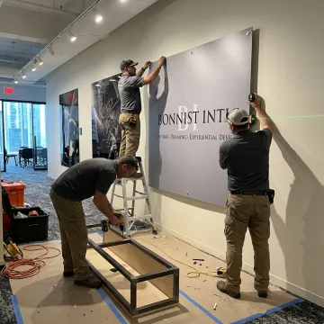 Team installing branded experiential display