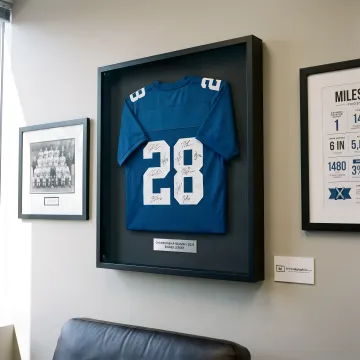 Custom framed sports jersey on a wall