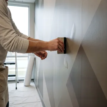 Installer applying a branded vinyl wall wrap