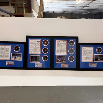 Designer preparing custom memorabilia framing
