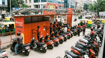 Bounce Daily battery swapping hub with riders exchanging depleted scooter batteries in Bengaluru