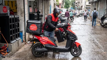 Bounce Daily electric scooter with swappable battery system at charging hub station