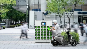Electric scooter battery swap station with rider exchanging discharged battery pack