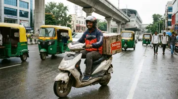 Bounce Daily delivery partner riding electric scooter in Bengaluru city traffic