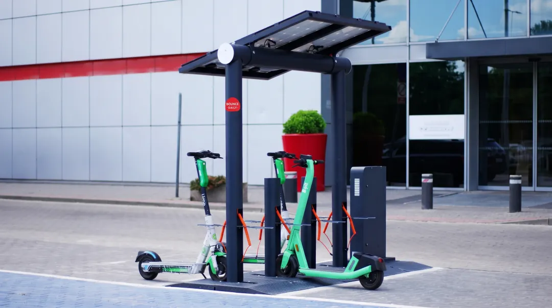 Electric scooter rental hub with EV fleet and charging infrastructure in urban location