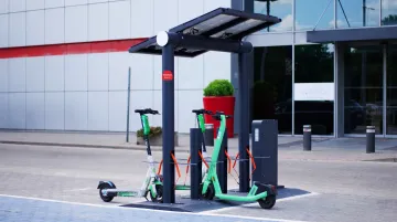 Electric scooter rental hub with EV fleet and charging infrastructure in urban location
