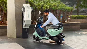 Ather Grid fast charging station with electric scooter plugged in urban setting