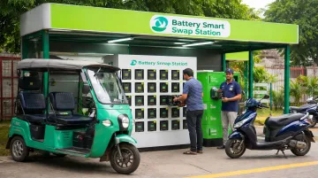 Electric vehicle battery swapping station with rider exchanging scooter battery
