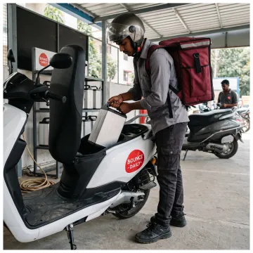 Delivery partner swapping an EV scooter battery