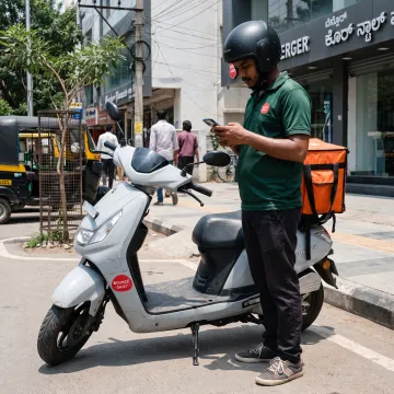 Rider checking delivery work on a phone