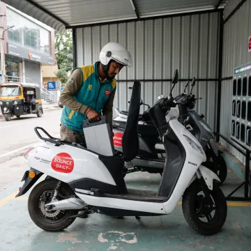 Rider swapping an EV scooter battery