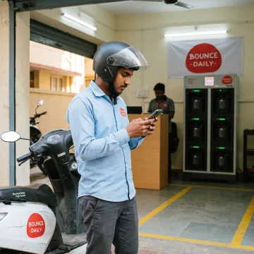 Delivery partner collecting an EV scooter at a hub