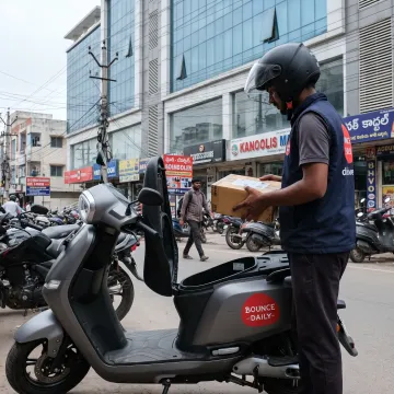 Delivery rider using an electric scooter in Hyderabad