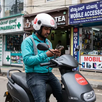 Delivery rider using an electric scooter