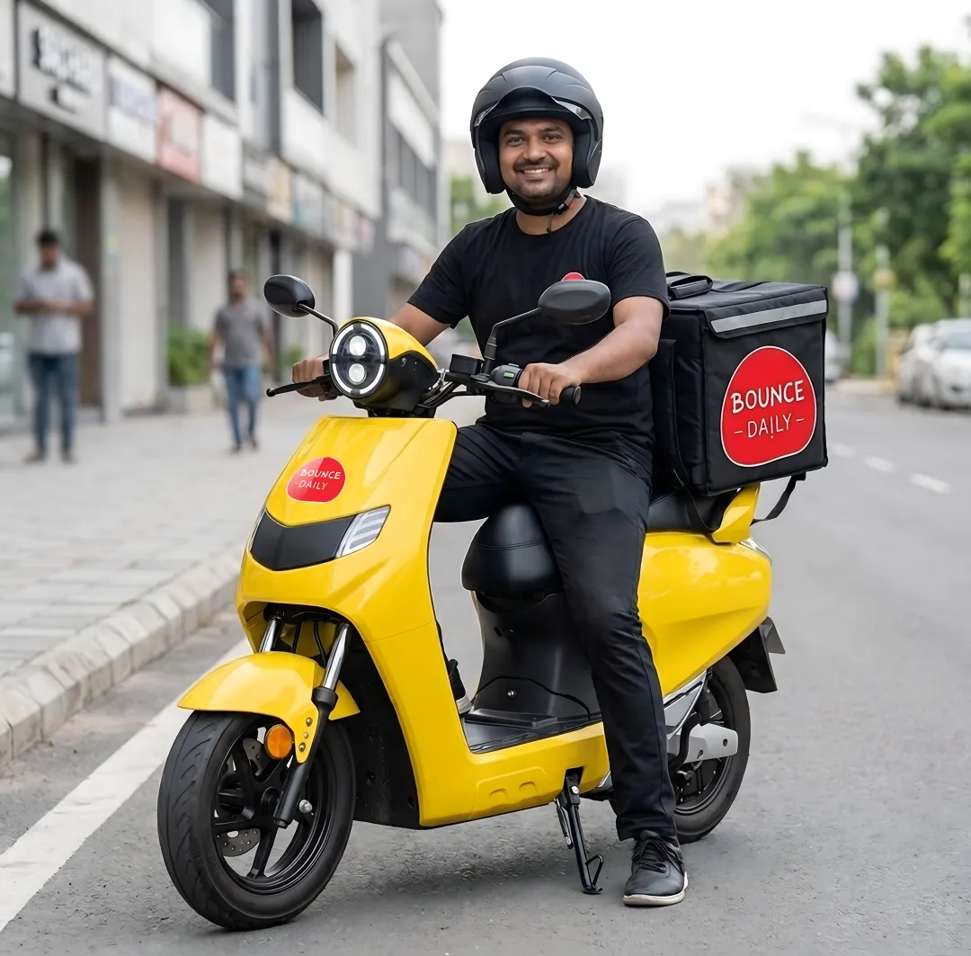 Rider picking up a Bounce Daily electric scooter