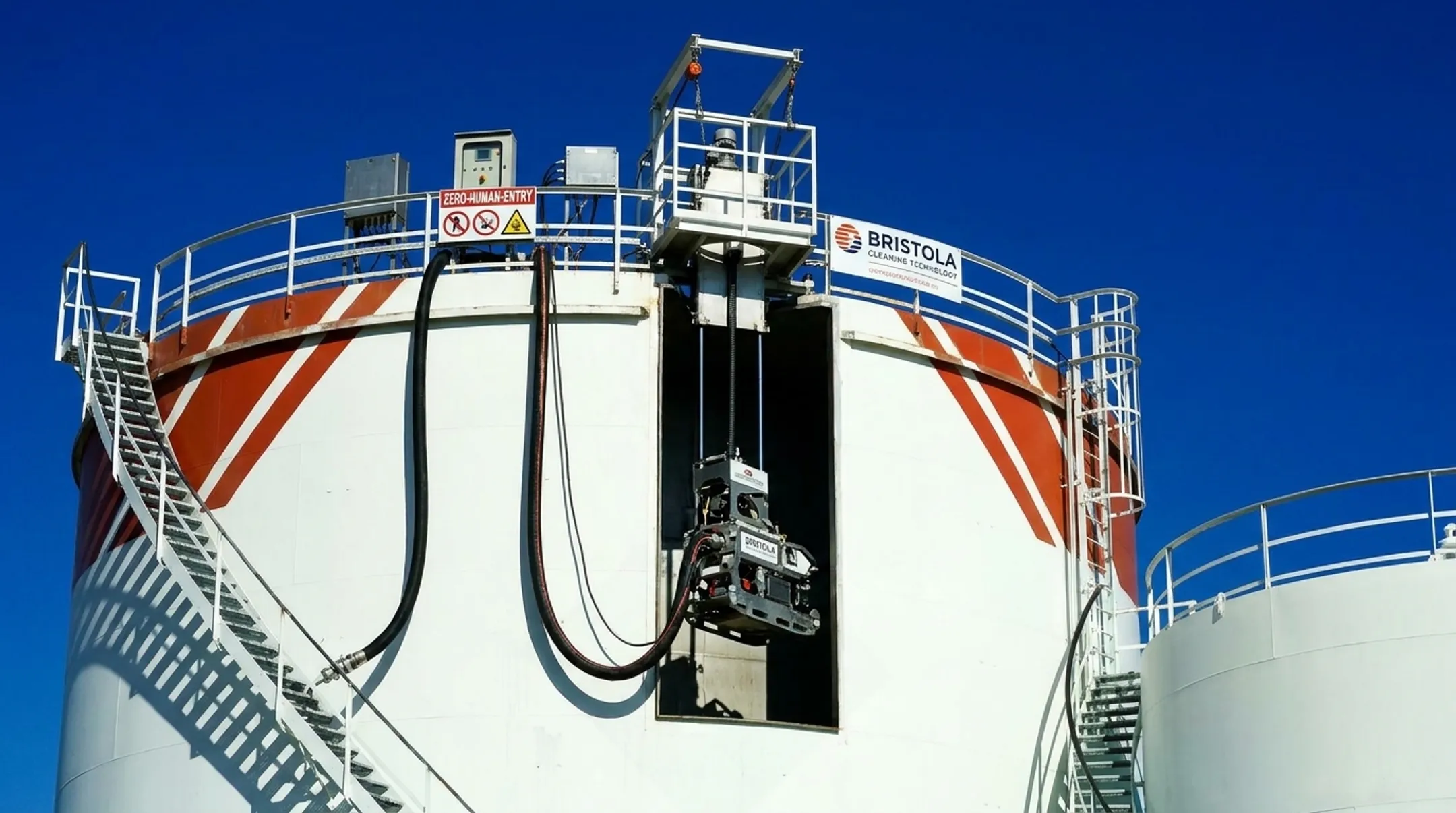 Robotic ROV submersible cleaning system entering tank through manhole access