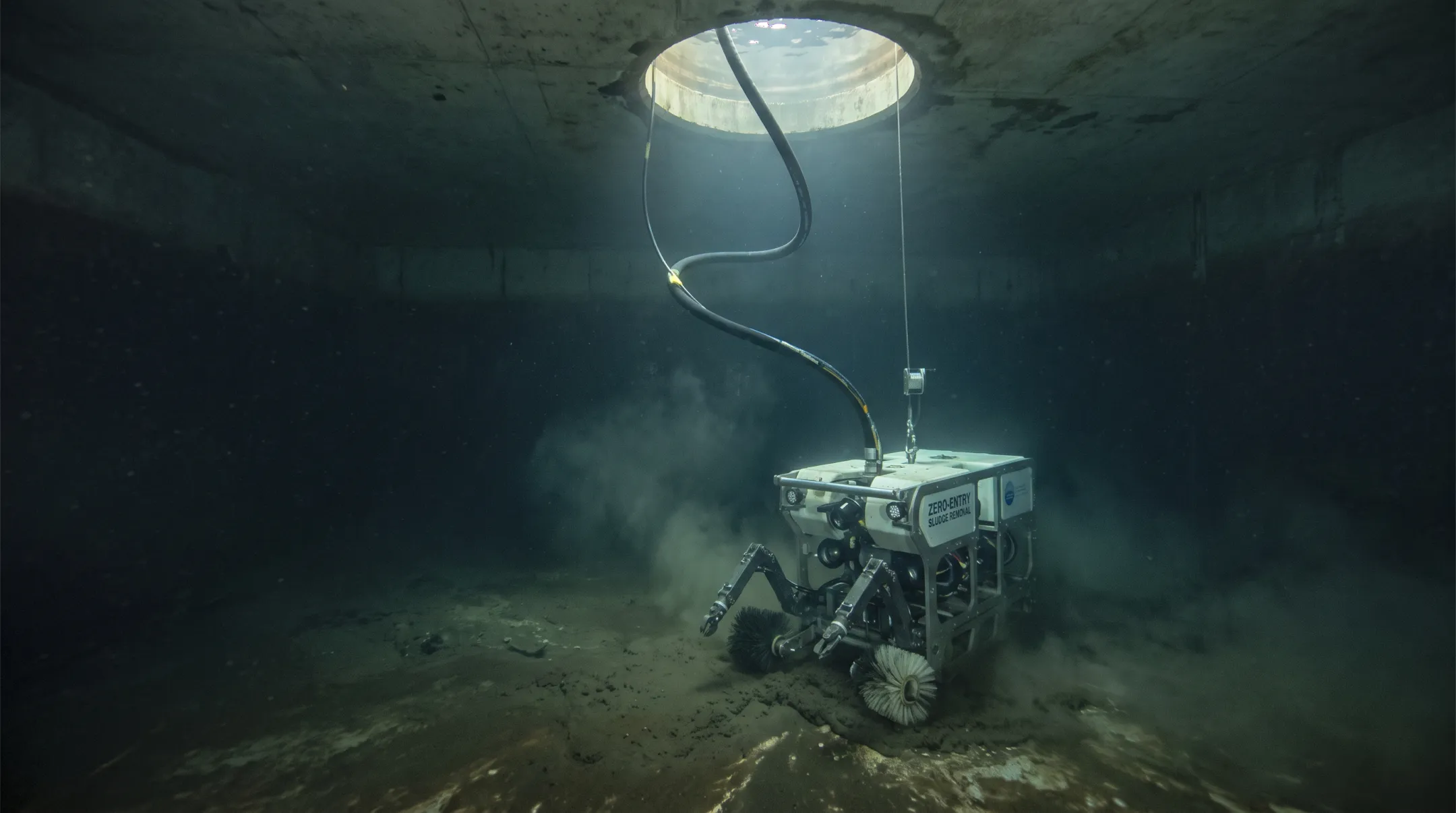 Submersible robotic cleaning system removing sludge inside active settling tank