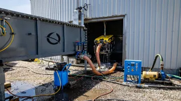 Bristola ROV submersible robot entering active industrial tank through equalization chamber port