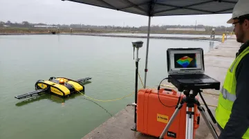 Industrial sonar ROV system mapping sediment accumulation inside non-covered storage pond