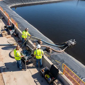 Technicians supporting robotic lagoon cleaning
