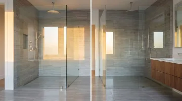 Curbless walk-in steam shower with large format tile and frameless glass enclosure