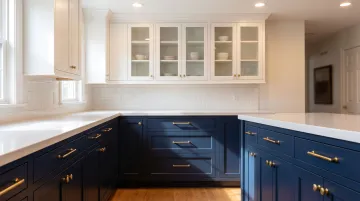 Two-toned kitchen with dark navy base cabinets and white upper cabinets