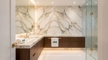 Book-matched marble vanity wall with symmetrical butterfly vein pattern in luxury bathroom