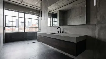 Concrete gray quartz vanity countertop installed in modern minimalist NYC bathroom