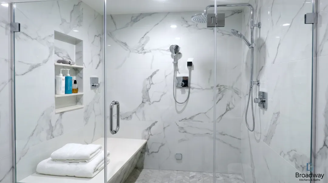 Luxury walk-in shower conversion with frameless glass enclosure and premium tile finishes