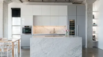Modern flat panel slab kitchen cabinets in open-plan contemporary home