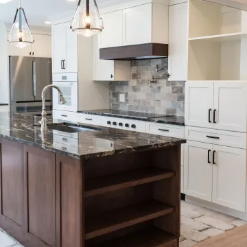 Installed commercial kitchen with custom cabinetry and stone counters