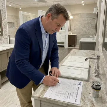 Designer measuring an accessible bathroom vanity layout
