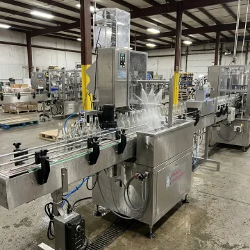 Bottle washing machine in a packaging line