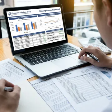 Consultant analyzing parcel shipping rates and carrier contract terms