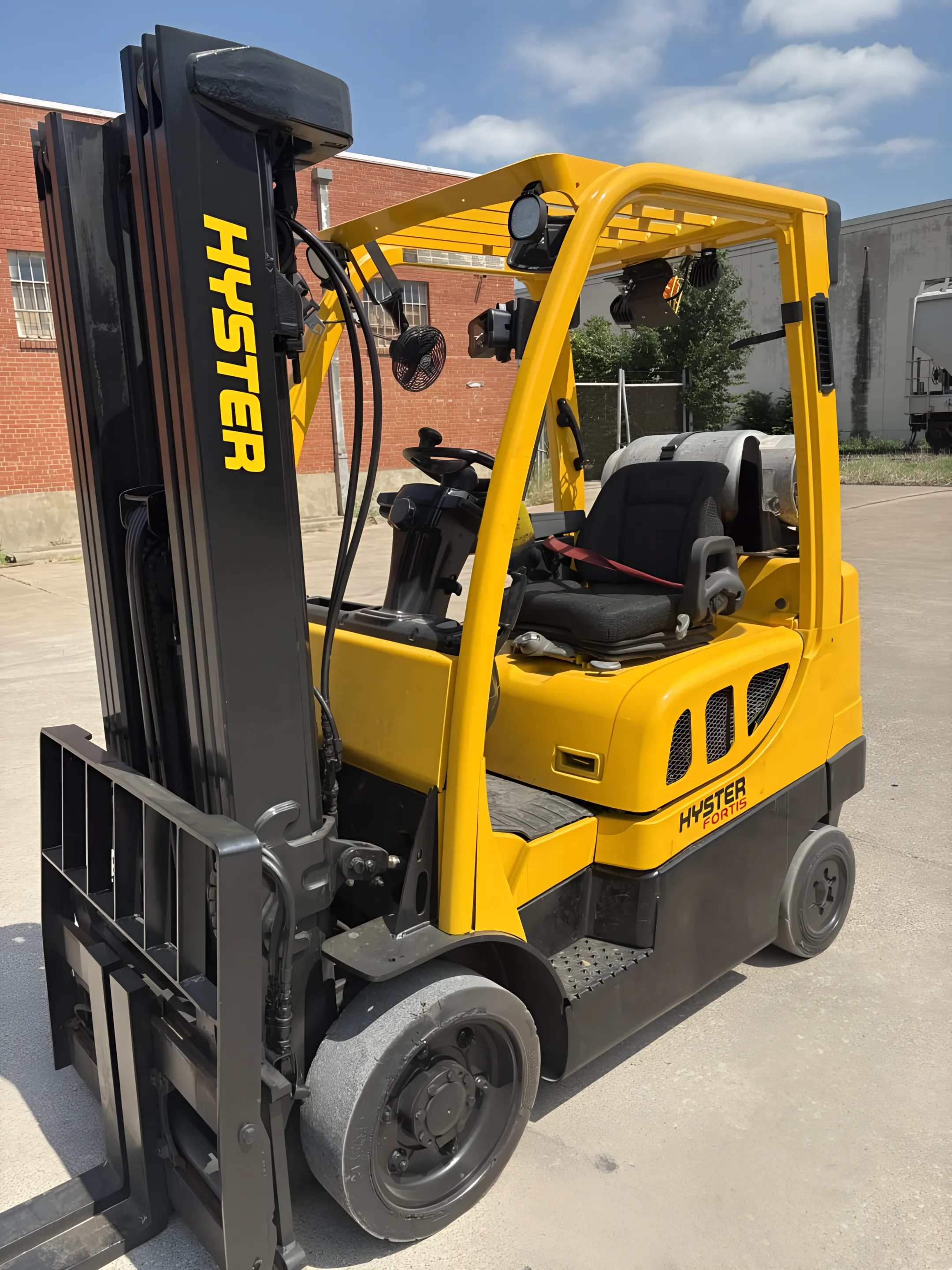 Construction yard forklift moving building materials